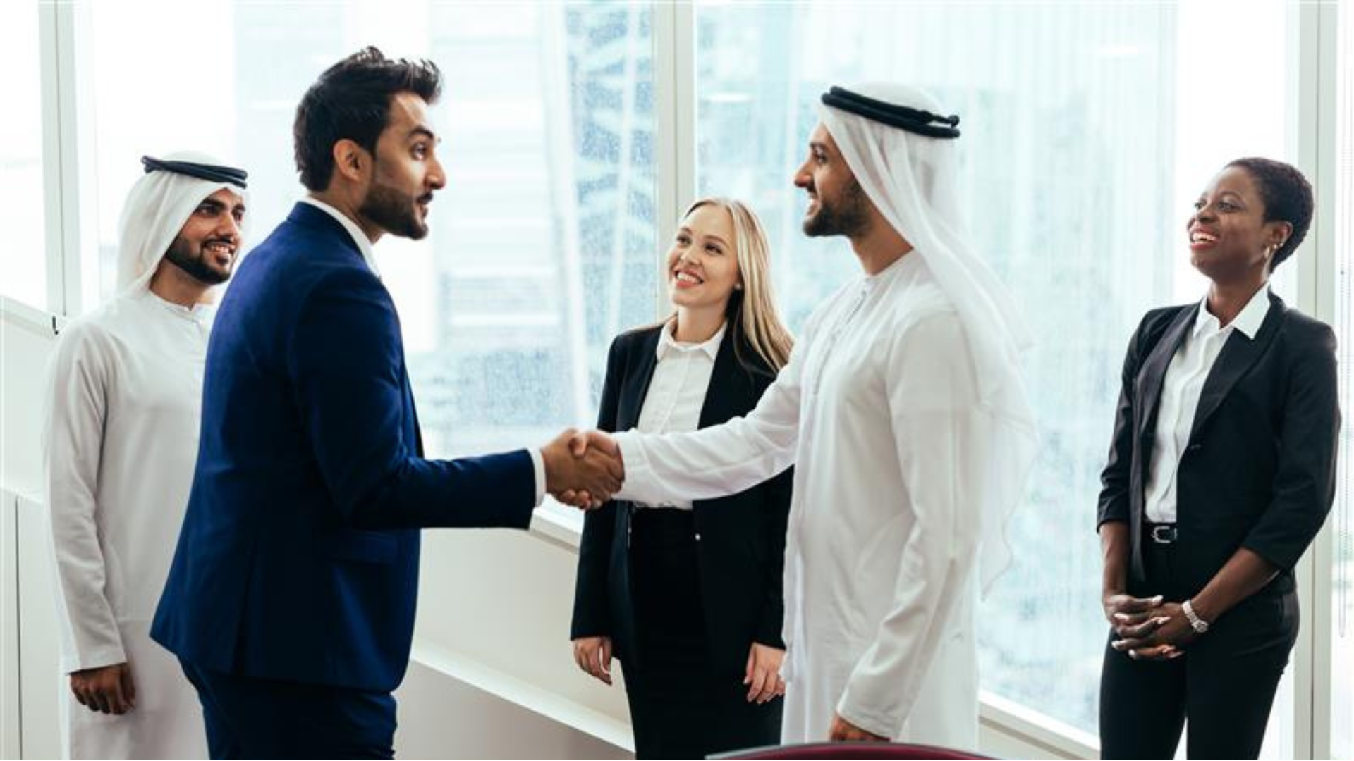 Multinational business team in Dubai discussing recruitment and staffing solutions